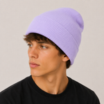 A man wearing a light purple ribbed knit beanie hat, shown in profile against a plain light grey background.