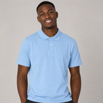 A smiling man wearing a light blue short-sleeve polo shirt, photographed against a plain light grey studio background.