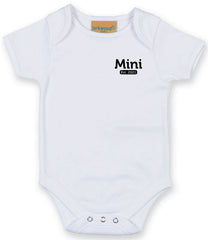 White baby onesie with short sleeves, featuring the text 'Mini Est. 2021' in Black on the left chest area and snap closures at the bottom