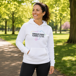 A woman wearing a white pullover hoodie with a 'Kirkcaldy Parks Running Festival' graphic on the chest, standing on a park path with trees in the background.