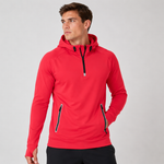A man wearing a bright red athletic pullover hoodie with black zipper accents and a black drawstring hood, photographed against a light gray studio background.
