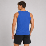 A man shown from the back wearing a bright blue sleeveless athletic tank top and black shorts against a light gray studio background.