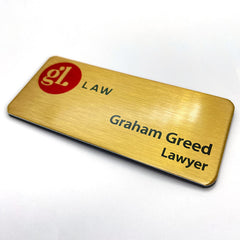 Gold name badge printed with logo and staff name