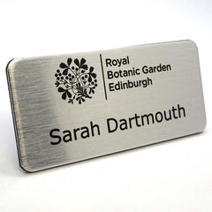 Silver printed name badge complete with logo