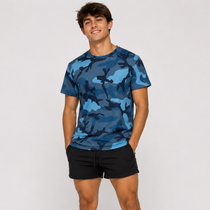 A man wearing a blue camouflage crewneck t-shirt and black shorts, standing against a light gray studio background.