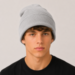 A young man wearing a light grey ribbed knit beanie hat and a black t-shirt, photographed against a neutral light grey background.