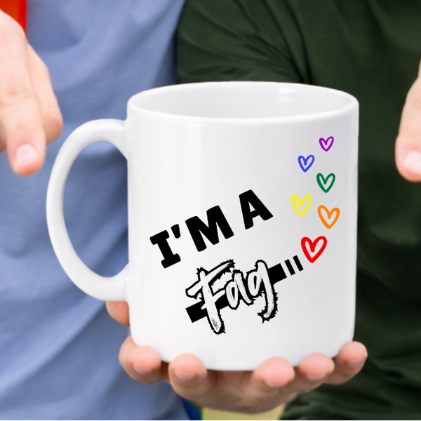 Two people holding a mug with colourful text outdoors
