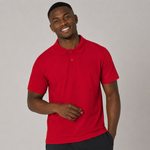 A smiling man wearing a red short-sleeve polo shirt, standing against a plain light grey studio background.