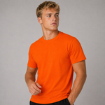 A man wearing a bright orange crew-neck t-shirt, photographed from the waist up against a neutral grey studio background.