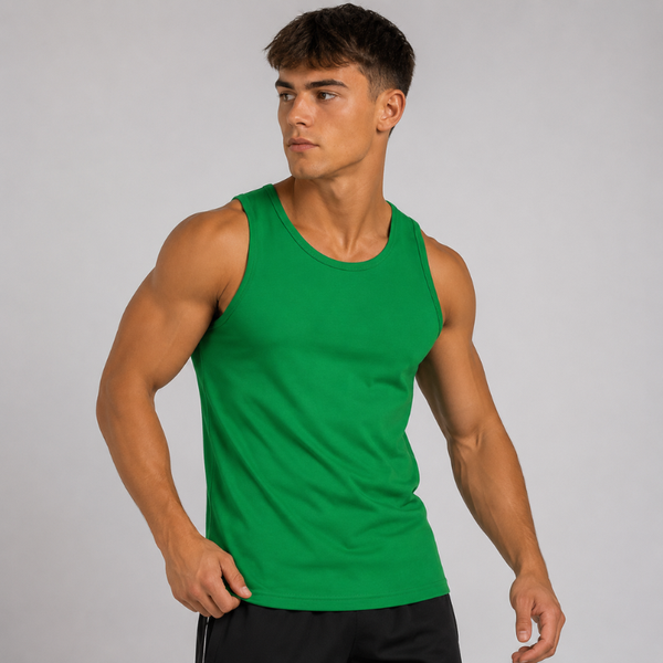 A muscular man wearing a bright green sleeveless tank top and black athletic shorts, posing against a light gray studio background.
