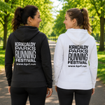 Two women standing on a park path, shown from the back, wearing matching hoodies. The woman on the left wears a black hoodie with white text reading 'KIRKCALDY PARKS RUNNING FESTIVAL' and the website