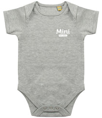 Grey baby onesie with short sleeves, featuring the text 'Mini Est. 2021' in white on the left chest area and snap closures at the bottom.