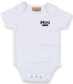 White baby onesie with short sleeves, featuring the text 'Mini Est. 2021' in Black on the left chest area and snap closures at the bottom