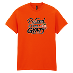 A bright orange short-sleeve crewneck t-shirt with a graphic on the chest that reads 'Pretend I have a GYATT' in black and white script, accompanied by a small peach illustration, shown on a plain white background.