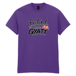 A purple short-sleeve crewneck t-shirt with a graphic on the chest that reads 'Pretend I have a GYATT' in stylized black and white lettering, accompanied by a small peach illustration, shown on a plain white background.