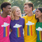 Four smiling young adults standing outdoors wearing matching graphic T-shirts with a white cloud and rainbow print. The shirts are in bright pink, purple, yellow, and green, and the group is photographed in a sunny outdoor setting with trees and a blurred background.