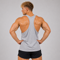 A muscular man shown from the back wearing a light gray racerback tank top and black athletic shorts, standing against a solid light gray studio background.
