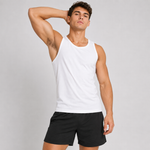 A muscular man wearing a white sleeveless tank top and black athletic shorts, posing against a light gray studio background.