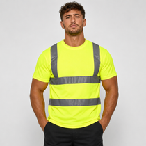 A man wearing a high-visibility neon yellow short-sleeve t-shirt with reflective gray horizontal and vertical stripes, paired with black pants, against a light gray studio background.